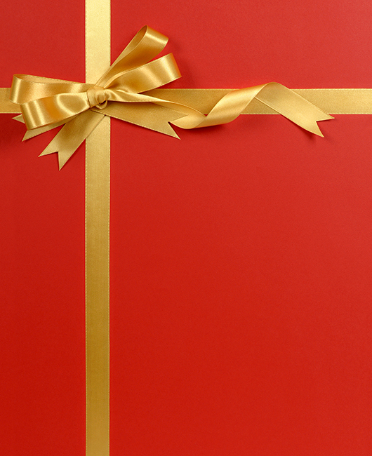 one flip flop and a piggy bank with sunglasses on a beach.